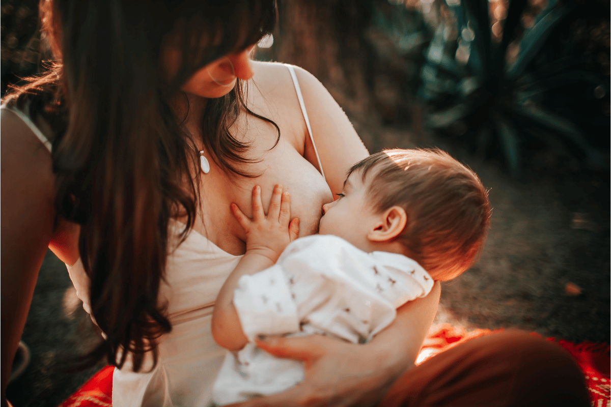 Woman Sitting and Breastfeeding Baby