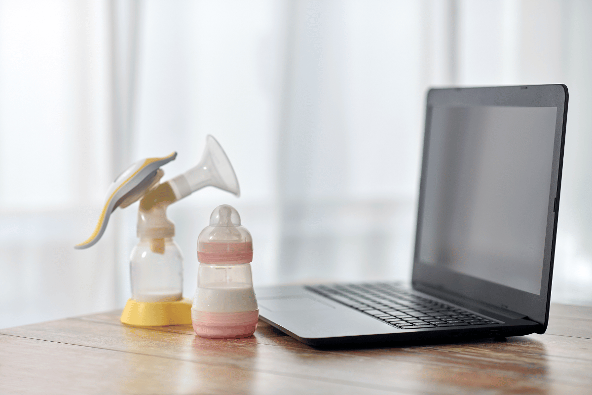 Baby Milk Formula, Breast Pump and Laptop on Table 