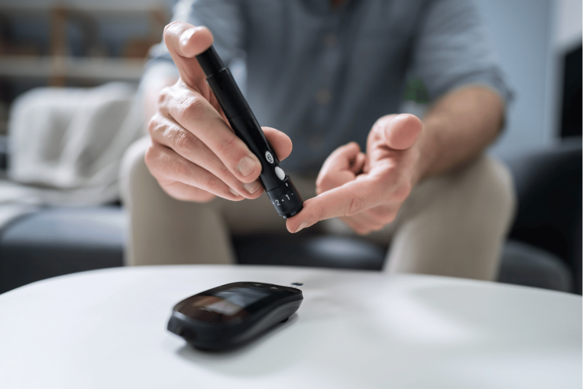 Close-up Of A Man's Hand Testing HighBlood Sugar With Glucometer