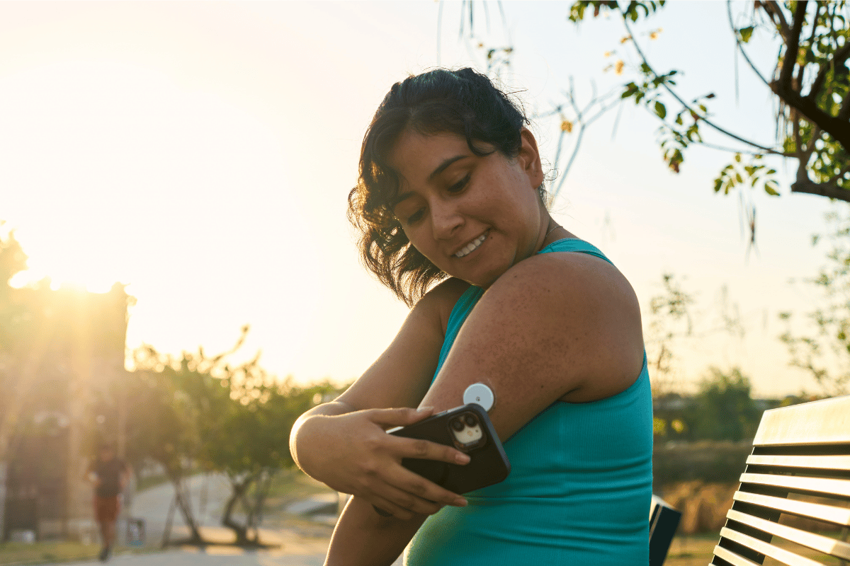 Diabetic patient woman doing exercises. Continuous Glucose Monitor and active sugar diabetes lifestyle